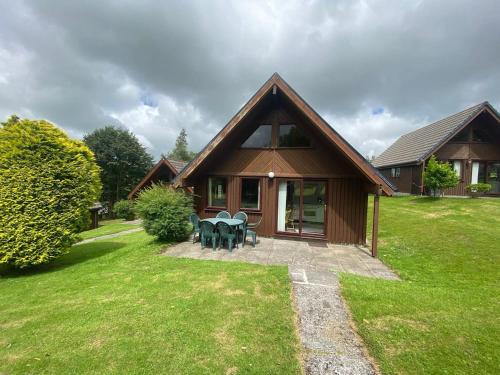 ein Haus mit einem Picknicktisch davor in der Unterkunft 3 Bedroom Lodge Lanteglos 21 in Lanteglos