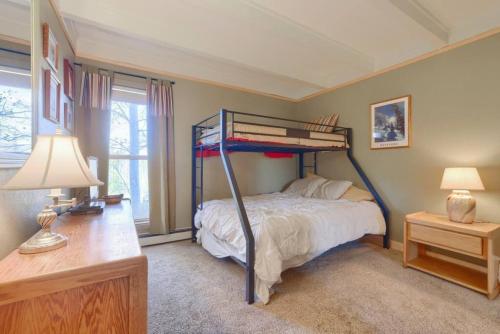 a bedroom with a bunk bed and a desk at Pet Friendly With A Fireplace A Pool Near Mountain Biking And Skiing in Silverthorne