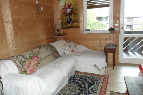 a living room with a white couch and a window at Villa 5 Torri in Cortina dʼAmpezzo