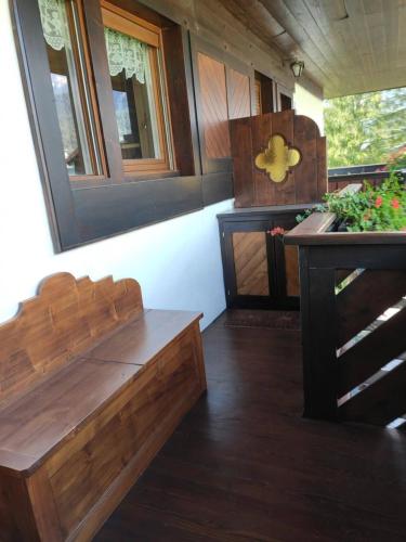 a room with a wooden bench and a sink at Villa 5 Torri in Cortina dʼAmpezzo