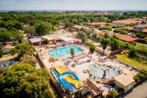 une vue aérienne d'une piscine dans un complexe hôtelier dans l'établissement Camping 4 étoiles - Piscine - ccb0e0h, à Torreilles