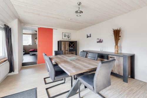 a dining room with a wooden table and chairs at Maison pour 5 personnes à 950 m de la plage in Trévou-Tréguignec