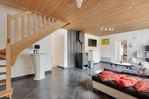 a living room with a bed and a staircase at Maison pour 5 personnes à 950 m de la plage in Trévou-Tréguignec
