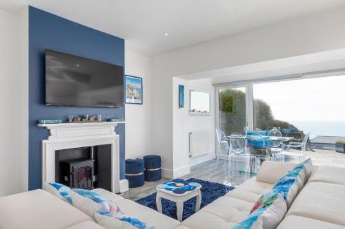 a living room with a white couch and a fireplace at Wave Watcher Seaview Escape Near Beach & Centre in Brighton & Hove