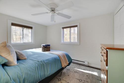 a bedroom with a bed with a ceiling fan at Family Friendly Cabin With A Firepit And A Hot Tub In Heart of Poconos in Pocono Pines