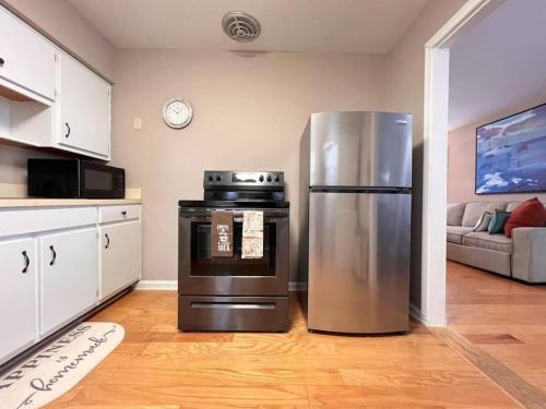 a kitchen with a stainless steel refrigerator in a room at 318) Extended Stay in Newport News