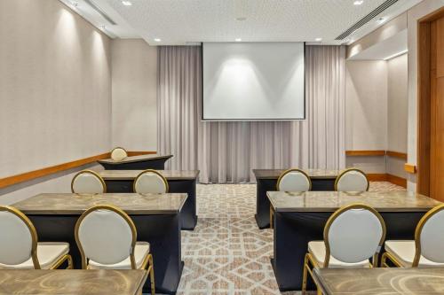 a conference room with chairs and a projection screen at Barranquilla Marriott Hotel in Barranquilla