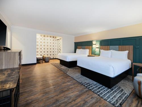 a hotel room with two beds and a television at Holiday Inn Resort The Squire at Grand Canyon by IHG in Tusayan