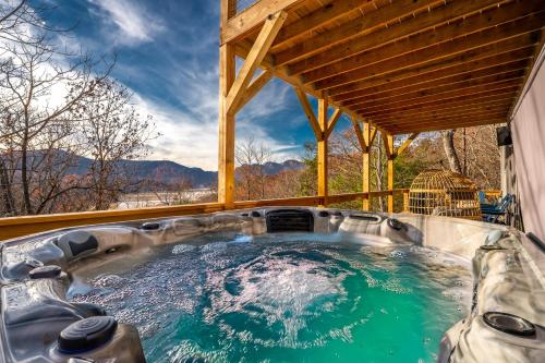 a hot tub on the back of a house at Wildview Retreat in Lake Lure