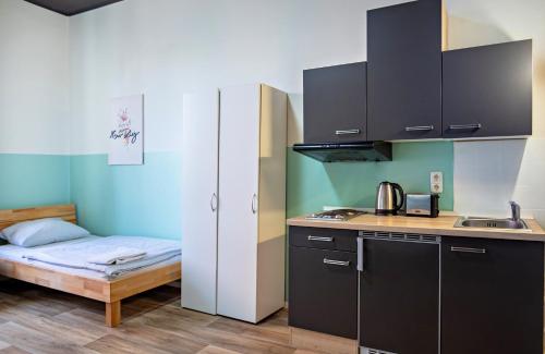 a small kitchen with a bed and a sink at Schwanthaler Hof in Munich