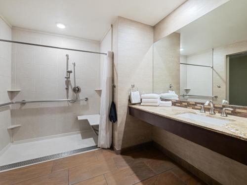 a bathroom with a tub and a sink and a shower at Holiday Inn Resort The Squire at Grand Canyon by IHG in Tusayan