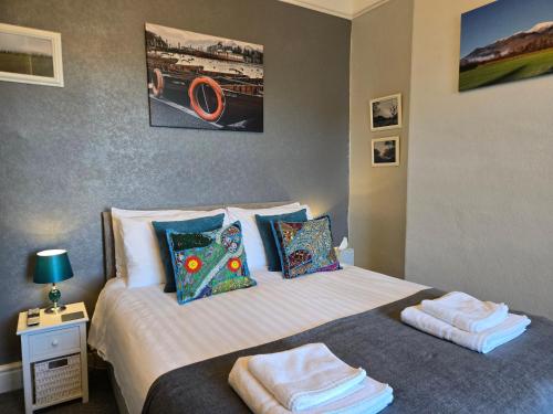 a bedroom with a bed with towels on it at Herdwick Guest House in Keswick