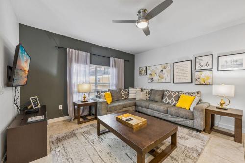 a living room with a couch and a table at Wonderful 4 bed Family Home with Private Pool in Kissimmee