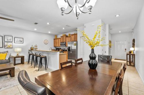 a dining room and kitchen with a table and chairs at Wonderful 4 bed Family Home with Private Pool in Kissimmee