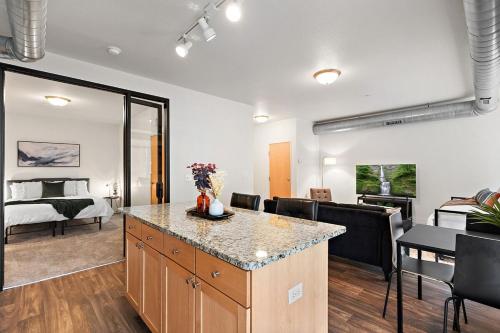 a living room with a kitchen and a bedroom at The Hazel Free parking, Gym, Fast WIFI, Central in Minneapolis
