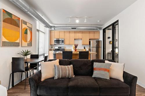 a living room with a couch and a kitchen at The Hazel Free parking, Gym, Fast WIFI, Central in Minneapolis