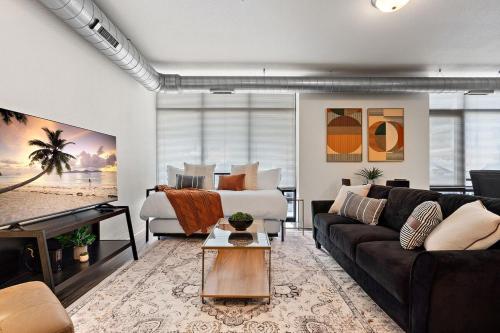 a living room with a couch and a piano at The Hazel Free parking, Gym, Fast WIFI, Central in Minneapolis