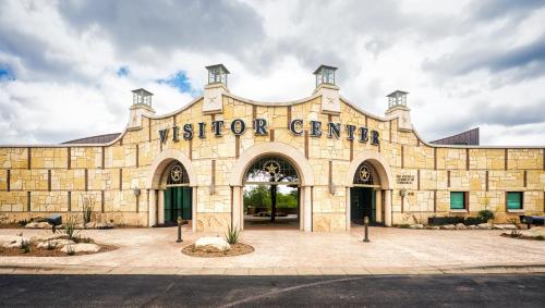 a stone building with the name of a visitor center at Pearl on the Concho in San Angelo