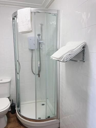 a shower with a glass door in a bathroom at The Crown Hotel in Corwen