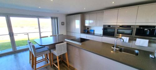 eine Küche mit Theke und Tisch mit Stühlen in der Unterkunft Ocean View in Perranporth
