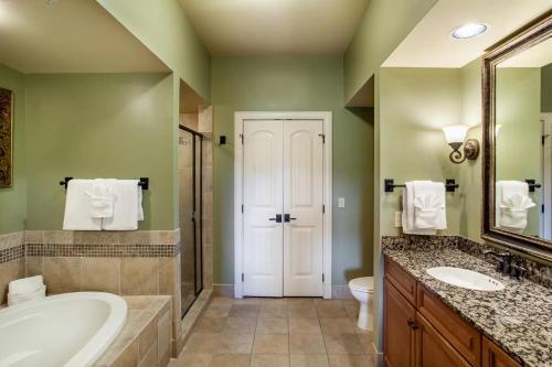 a bathroom with a tub and a sink and a toilet at Pigeon Forge Adventure #163 in Pigeon Forge