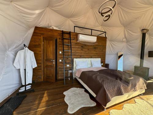 a bedroom with a bed in a tent at Charlton Estate in Yablunytsya