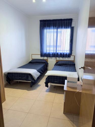two beds in a room with a window at Alicante Hills 1 in Alicante