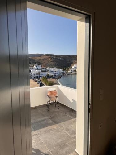 a room with a view of a balcony with a chair at Sea Sun Sand in Loutrá