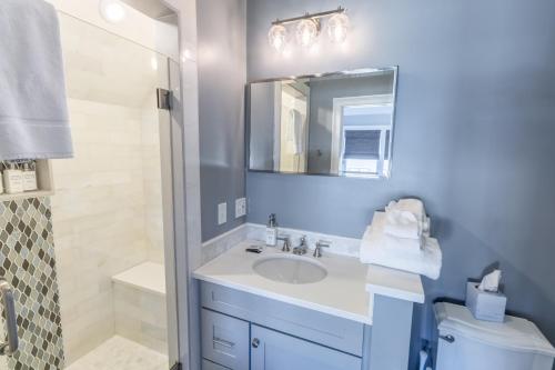a bathroom with a sink and a mirror at The Newport Lofts - 595 Thames Street in Newport