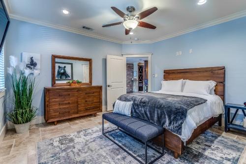 a bedroom with a bed and a ceiling fan at DFW Large Vacation Retreat with Private Pool and Hot Tub in Irving