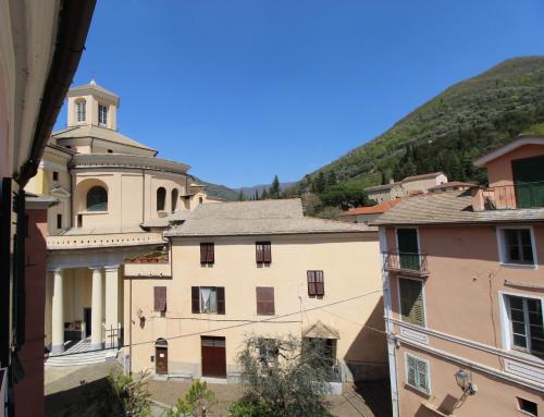 a view of a building with a hill in the background at La casa del pittore con climatizzatore Pieve di Teco centro in Pieve di Teco