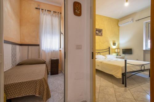 a bedroom with a bed and a desk in a room at Casa Loretta 2 in Valledoria