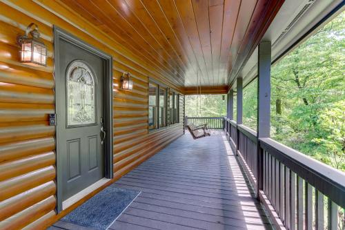 a wooden porch with a door and a bench on it at Waterfront Cabin in Ellijay Hot Tub and Game Room in Ellijay