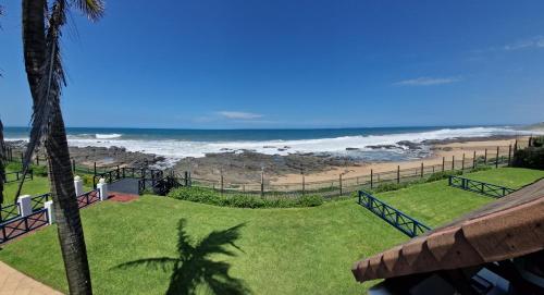 a view of the beach from the balcony of a resort at 26 Le Paradis in Ballito