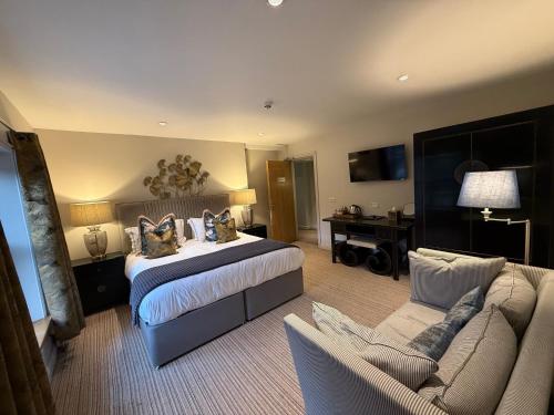 a hotel room with a bed and a couch at Hebden Townhouse in Hebden Bridge