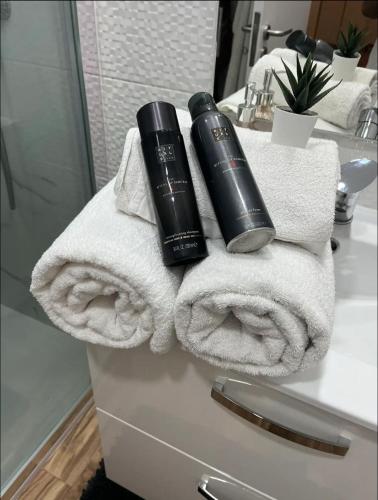 a pile of towels and a blow dryer on a bathroom counter at Apartamento centro histórico Porto in Porto