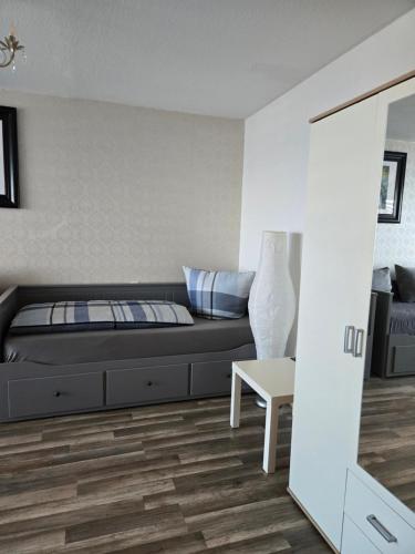 a bedroom with a black bed and a table at Apartment Katharina in Sinsheim