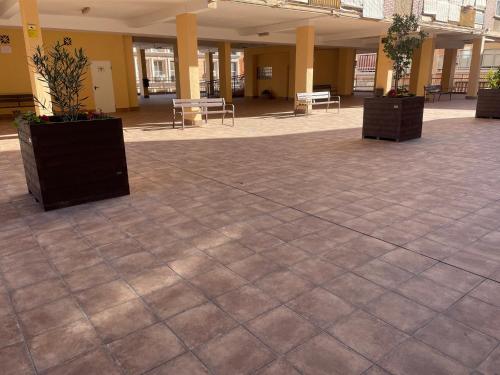 a lobby with a large tile floor with tables and chairs at Malagueando in Málaga