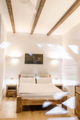 a bedroom with a large bed with white sheets at Kosa Śpiew Joga i Spa in Kosewo