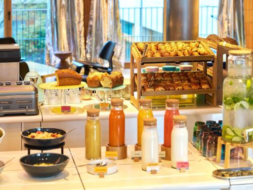 a bakery with a bunch of pastries on a counter at TRIBE Paris Clichy in Clichy