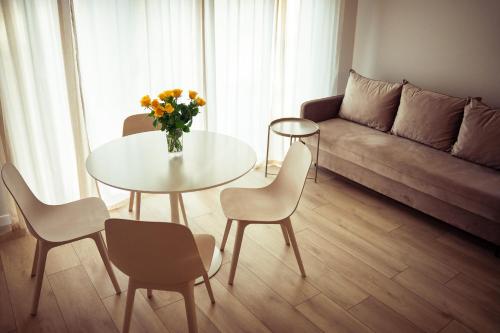 a living room with a table and chairs and a couch at Resort Hel domki letniskowe in Hel