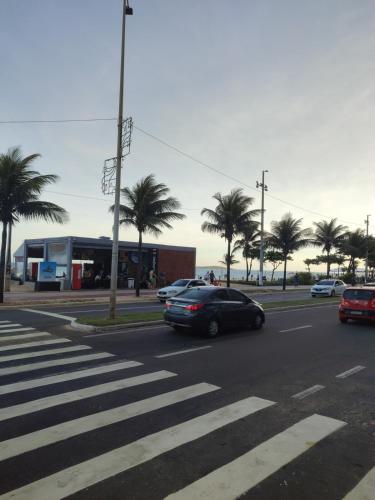 a car driving down a street with palm trees at Donatos home in Vila Velha