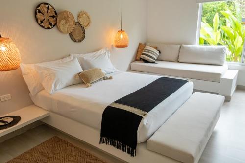 a bedroom with a large bed and a couch at Selva Serena in Anapoima