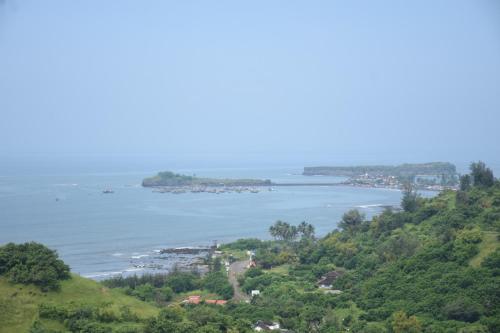 a view of the ocean from a hill at Nikhat villa 61 in Harnai