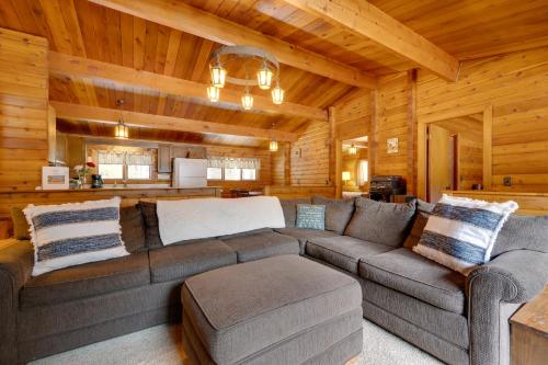 a living room with a couch in a log cabin at Hike and Ski Cabin with Fireplace in Franconia! in Franconia