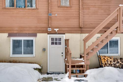 a house with a white door and a staircase at Hike and Ski Cabin with Fireplace in Franconia! in Franconia
