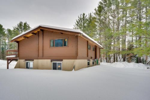a house in the snow in front at Hike and Ski Cabin with Fireplace in Franconia! in Franconia
