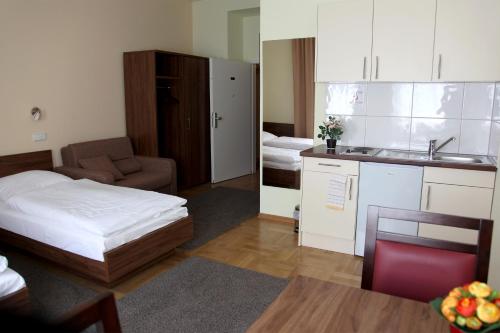 a small room with a bed and a kitchen at Hotel am Charlottenplatz in Esslingen