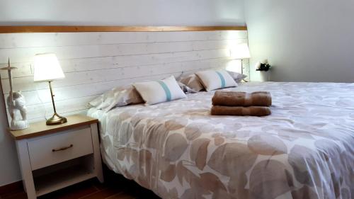 a bedroom with a large bed with a wooden headboard at Casa piscina privada climatizada Tarajalejo 3 habitaciones in Tarajalejo