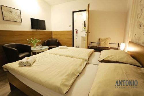 a hotel room with two beds and a television at Antonio Old Town Residence in Prešov